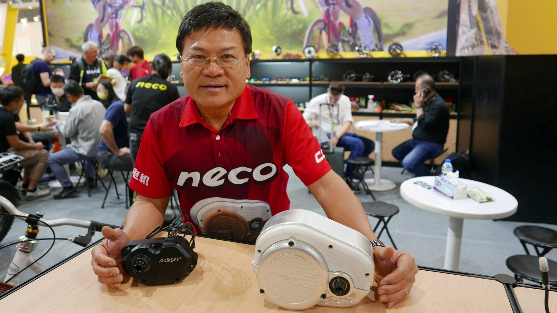Neco president Neco Wang with his company’s latest e-bike mid motors on display at Taipei Cycle 2023. – Photo Jo Beckendorff