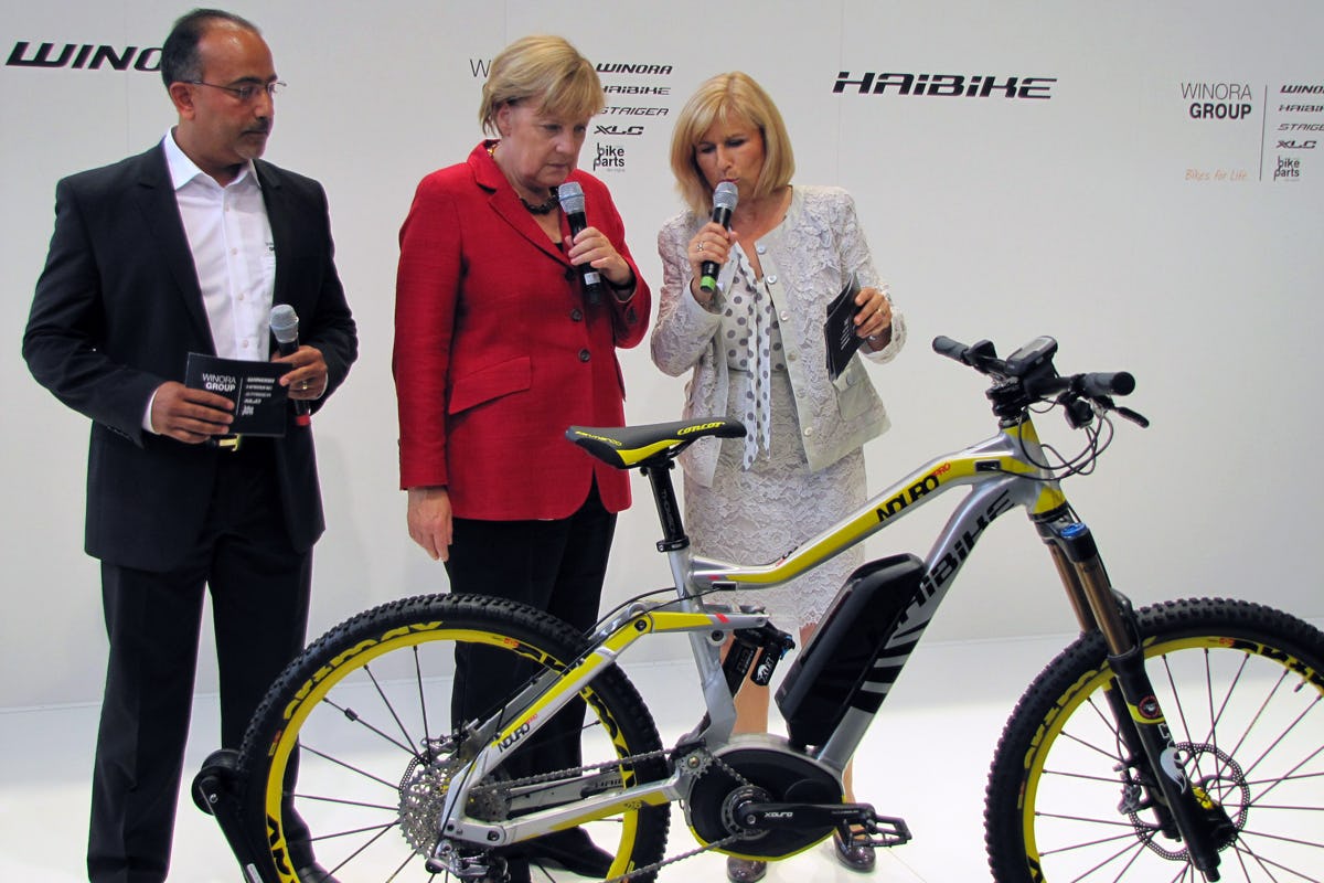 After her official show opening Angela Merkel stopped by some stands on the show floor. Pictured here is the explanation she got from Susanne and Felix Puello on the new Haibike e-bikes.