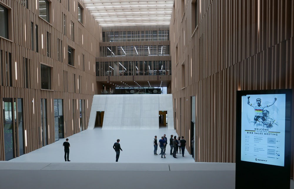 The atrium of the new Scott Sports Group building is made up of concrete, wood and glass. – Photos Jo Beckendorff